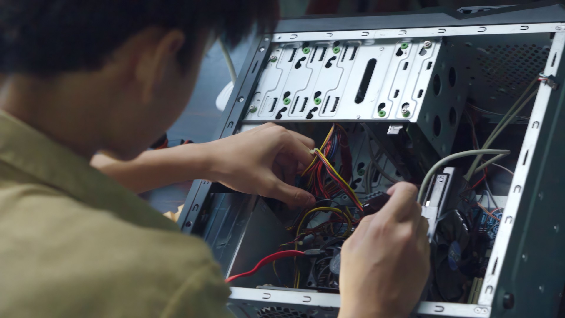 Close up hand asian young boy learning to repair computer and electronic board in the classroom.  Engineering electronic education in colleges.